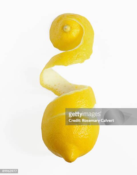 coil of lemon peel removed from lemon - lemon peel stock pictures, royalty-free photos & images