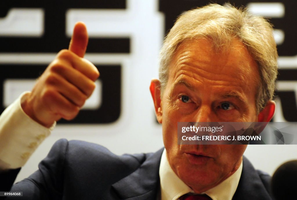 Former British prime minister Tony Blair gestures at a briefing for