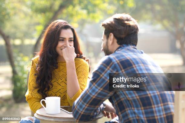 romantic indian couple having coffee at park - bonding stock pictures, royalty-free photos & images