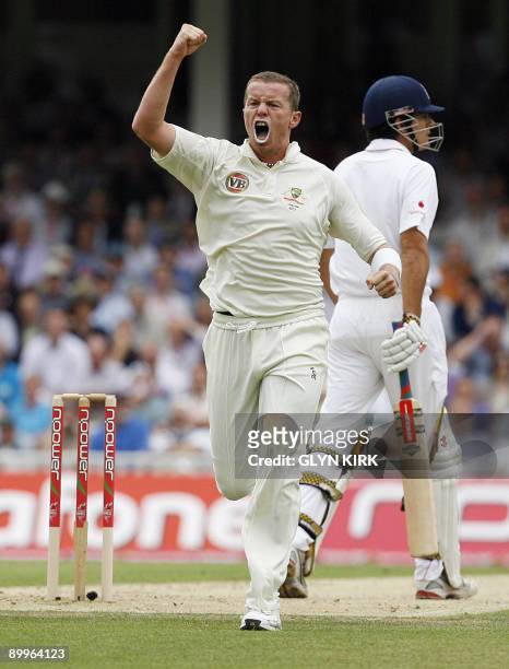 Australian bowler Peter Siddle celebrates the wicket of England's Alastair Cook after he is caught by Ricky Ponting for 10 on the first day of the...