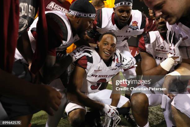 Running back Larry Rose III of the New Mexico State Aggies celebrates with teammates after scoring the game winning touchdown in overtime of the Nova...