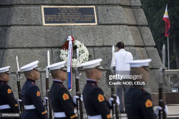 Philippines' President Rodrigo Duterte offers a wreath during the commemoration of the 121st death anniversary of the country's national hero Jose...