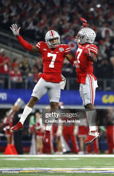 Damon Webb and Jerome Baker of the Ohio State Buckeyes celebrate after Baker recovered a fumble in the first half of the 82nd Goodyear Cotton Bowl...