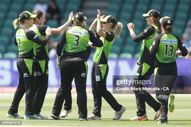 Nicola Carey of the Thunder celebrates with team mates after taking a catch to dismiss Lauren Winfield of the Hurricanes during the Women's Big Bash...