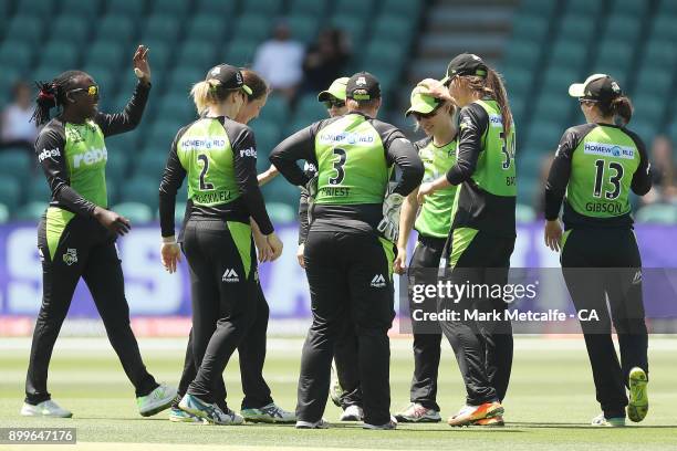 Nicola Carey of the Thunder celebrates with team mates after taking a catch to dismiss Lauren Winfield of the Hurricanes during the Women's Big Bash...