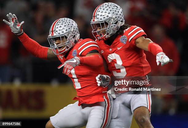 Damon Webb of the Ohio State Buckeyes celebrates his touchdown pass interception with Damon Arnette against the USC Trojans in the second quarter...