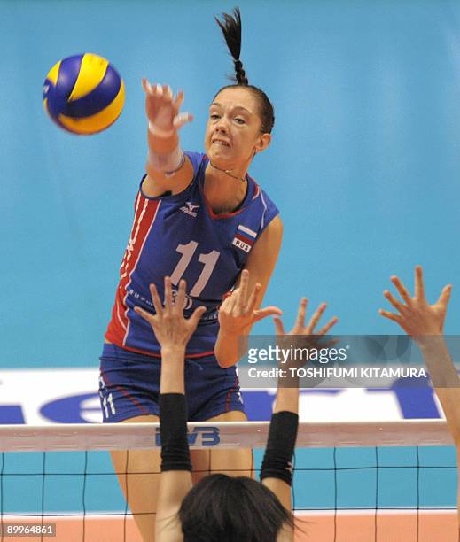 Russia's Ekaterina Gamova spikes the ball above Japan's Mai Yamaguchi during their 2009 FIVB World Grand Prix women's volleyball final round match in...