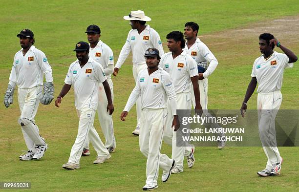 Sri Lankan cricketers are led by captain Kumar Sangakkara as they leav the pitch at the end of the third day of the first Test match between Sri...