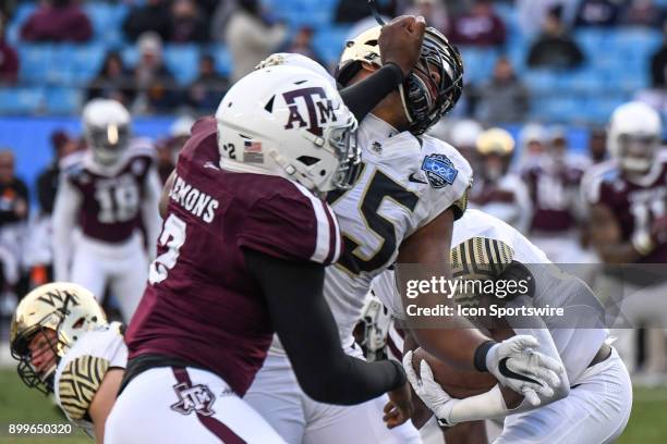 Texas A&M Aggies defensive lineman Micheal Clemons fights through a block by Wake Forest Demon Deacons offensive lineman Justin Herron during the...