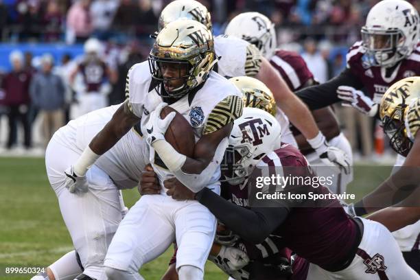 Wake Forest Demon Deacons running back Arkeem Byrd is wrapped up on a run during the Belk Bowl between the Wake Forest Demon Deacons and the Texas...