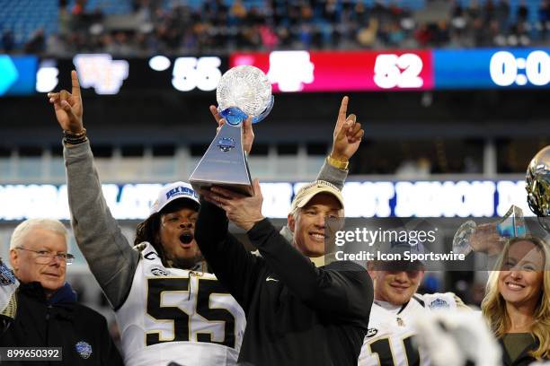 Wake Forest Demon Deacons head coach Dave Clawson holds up the the trophy after winning 55-52 over the Texas A&M Aggies in the Belk Bowl on December...