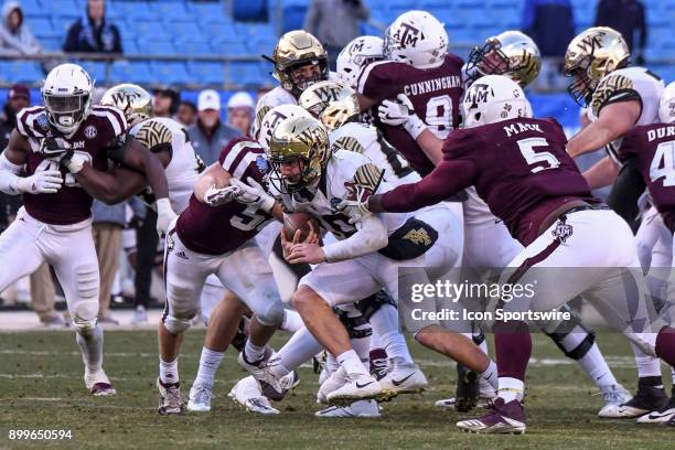 Wake Forest Demon Deacons quarterback John Wolford runs through a hole during the Belk Bowl between the Wake Forest Demon Deacons and the Texas A&M...