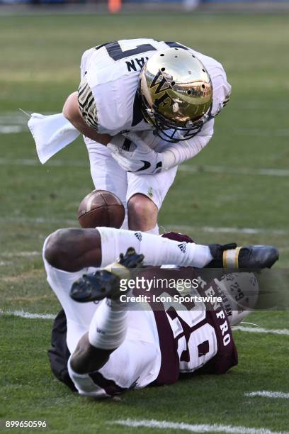 Wake Forest Demon Deacons wide receiver Alex Bachman fumbles after a catch and hit by Texas A&M Aggies defensive back Debione Renfro during the Belk...