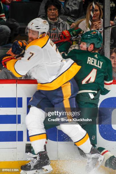 Yannick Weber of the Nashville Predators and Mike Reilly of the Minnesota Wild collide during the game at the Xcel Energy Center on December 29, 2017...