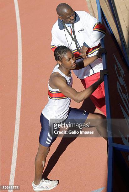 Year-old South African athlete Caster Semenya trains with her coach Michael Sponge Seme during a training session on August 4, 2009 in Pretoria,...