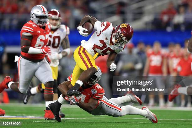 Ronald Jones II of the USC Trojans runs the ball against Jordan Fuller of the Ohio State Buckeyes in the third quarter during the Goodyear Cotton...