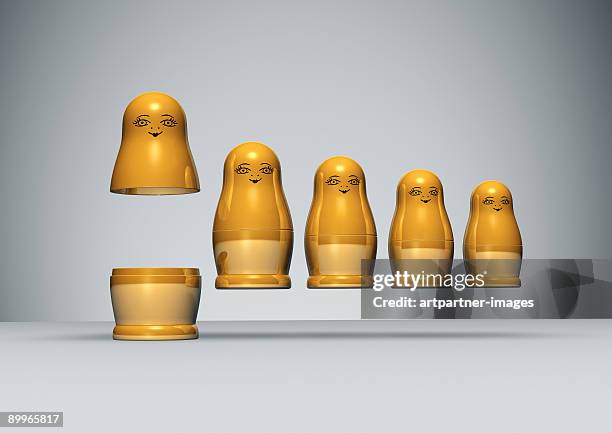 row of golden russian dolls - russian nesting doll stock pictures, royalty-free photos & images