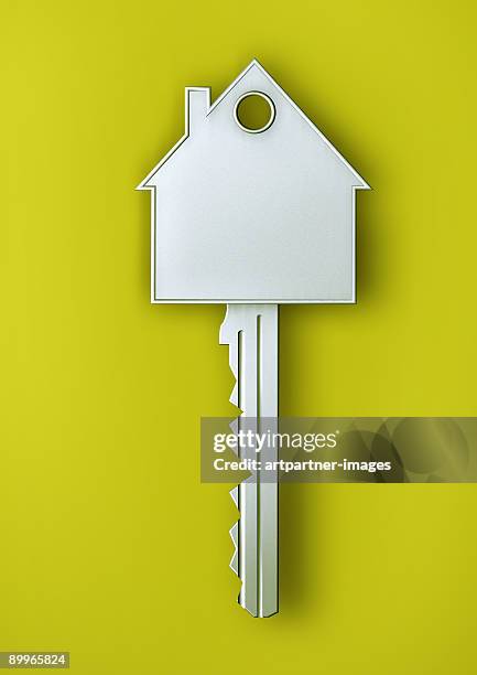 silver house key with a house - house keys stock pictures, royalty-free photos & images