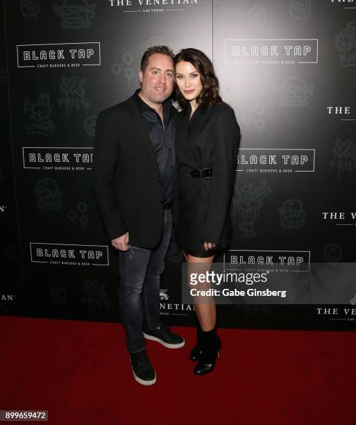 Co-owner of Black Top Craft Burgers & Beer Chris Barish and his wife Julie Barish attends the grand opening of Black Tap Craft Burgers & Beer at The...