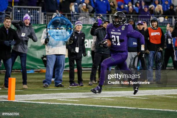 Northwestern Wildcats safety Kyle Queiro returns an interception for a touchdown during the Music City Bowl between the Kentucky Wildcats and the...