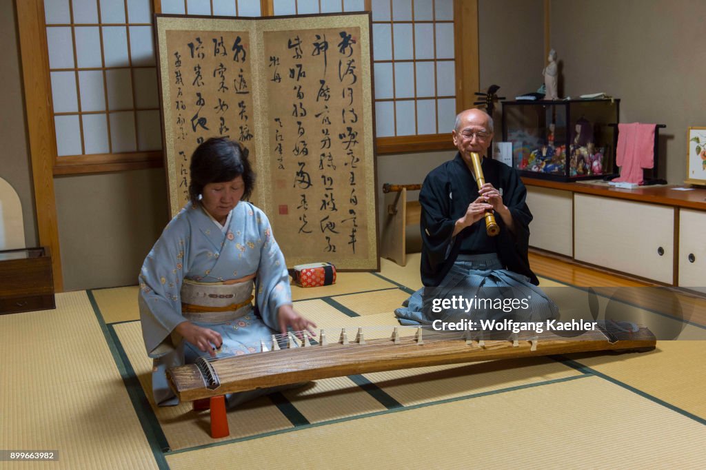 A Japanese couple in traditional clothing in Kyoto, Japan,...