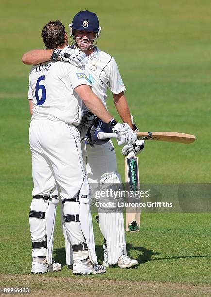 Michael Lumb of Hampshire is congratulated by Sean Ervine on reaching his double century during the LV County Championship Division One match between...