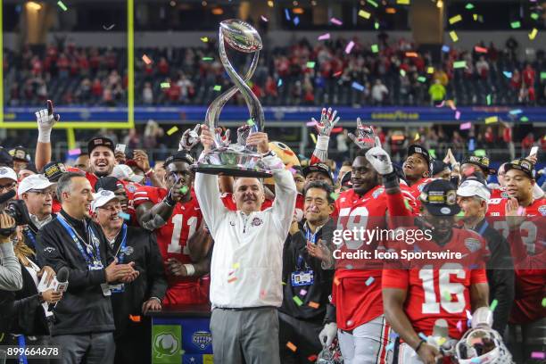 Ohio State Buckeyes head coach Urban Meyer lifts the trophy after winning the Goodyear Cotton Bowl Classic between Ohio State and USC on December 29...