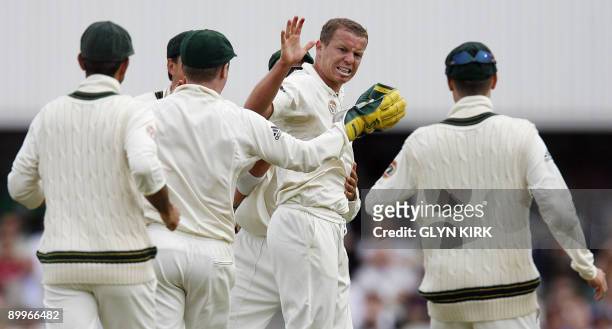 Australian bowler Peter Siddle celebrates with his team-mates the wicket of England's Paul Collingwood on the first day of the fifth and final Ashes...