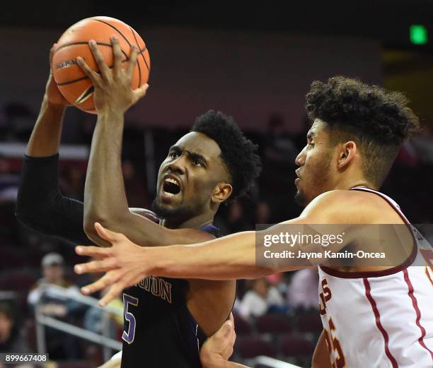 Bennie Boatwright of the USC Trojans guards Jaylen Nowell of the Washington Huskies as he drives to the basket in the second half of the game at...