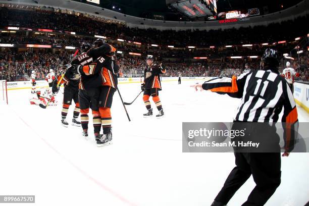 Referee Kelly Sutherland motions a goal as Ryan Getzlaf congratulates Rickard Rakell of the Anaheim Ducks on the goal during the third period of a...