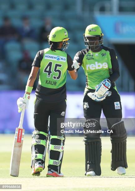 Stafanie Taylor of the Thunder and Harmanpreet Kaur of the Thunder celebrate victory in the Women's Big Bash League match between the Hobart...