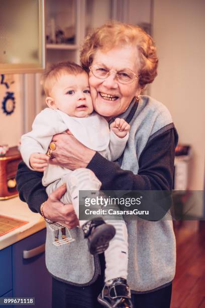 baby girl celebrating christmas with grandparents - great grandmother stock pictures, royalty-free photos & images