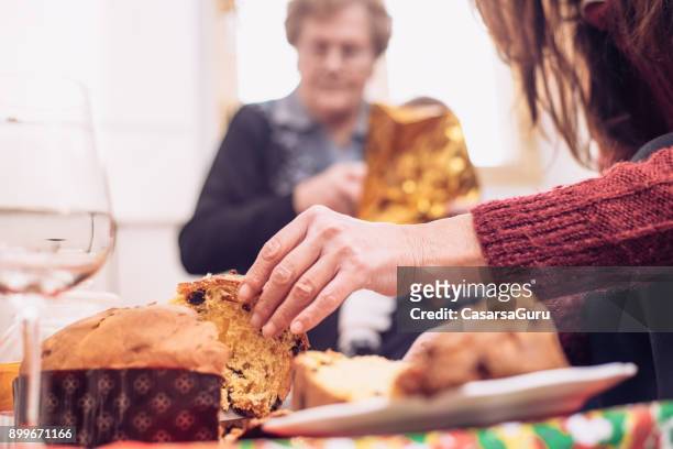 four generation women celebrating christmas together - panettone stock pictures, royalty-free photos & images