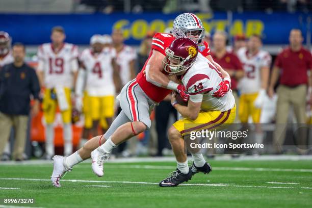 Trojans quarterback Sam Darnold is sacked by Ohio State Buckeyes linebacker Baron Browning during the Goodyear Cotton Bowl Classic football game...