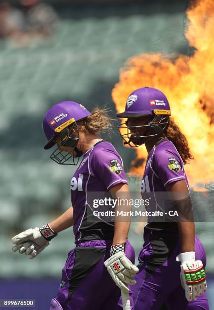 Hayley Matthews and Lauren Winfield of the Hurricanes walk out to bat during the Women's Big Bash League match between the Hobart Hurricanes and the...