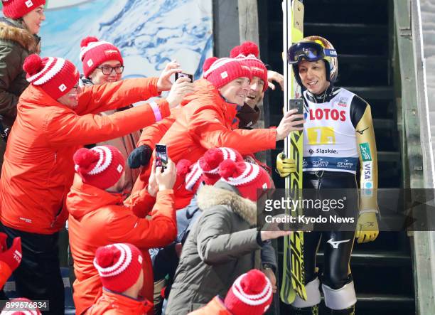Veteran Japanese ski jumper Noriaki Kasai poses for photographs with fans at a men's ski jumping World Cup meet in Wisla, Poland on Nov. 18, 2017....