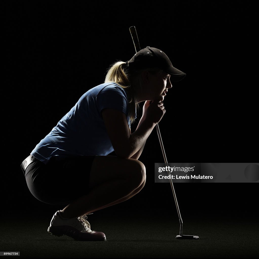 Golfer lining up a putt shot