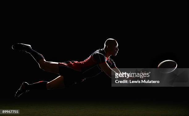rugby player making a diving pass of the ball - rugby sport foto e immagini stock