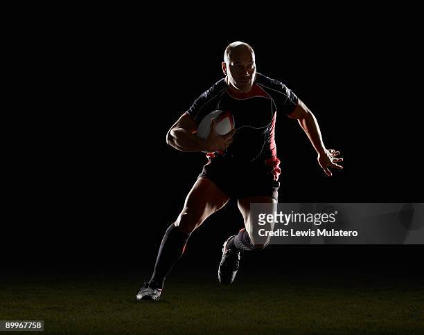 rugby player with ball side stepping - rugby ball stock pictures, royalty-free photos & images
