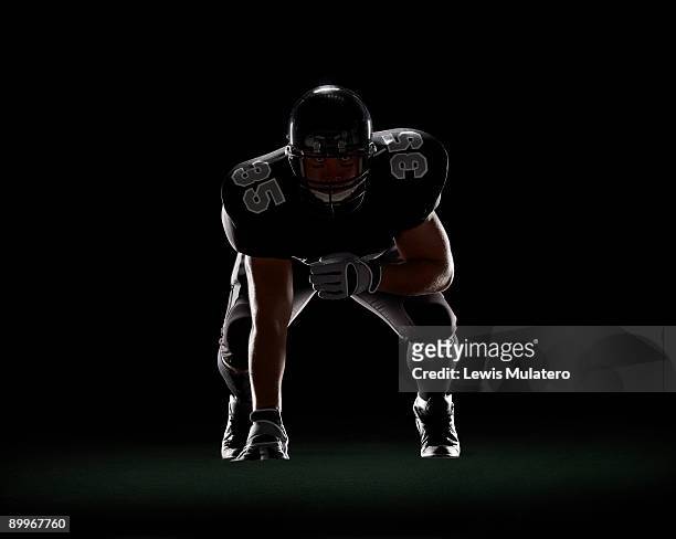 american football player in 3-point stance - american football player studio stock pictures, royalty-free photos & images