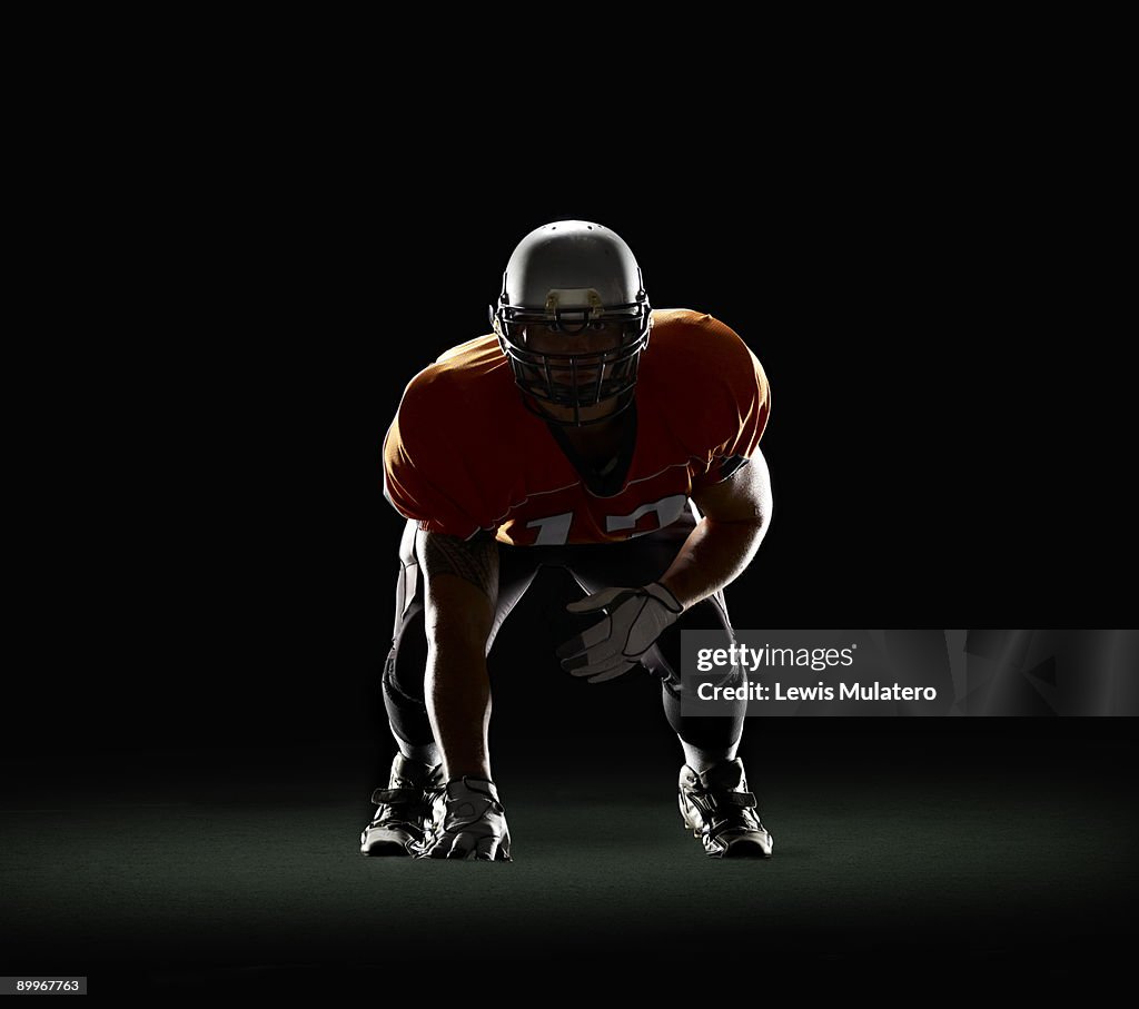 American Football Player In Threepoint Stance High-Res Stock Photo