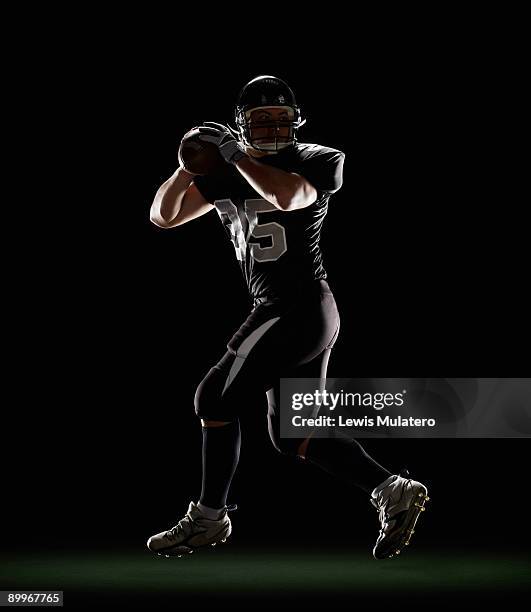 quarterback in three-step drop position - hurling sport stock pictures, royalty-free photos & images