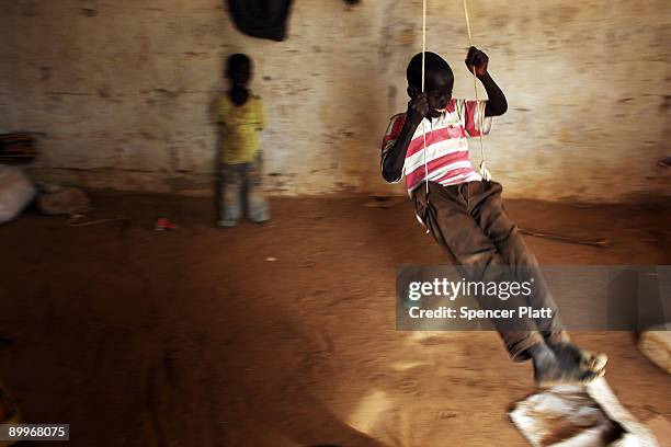 Child plays on a swing at a home in Dadaab, the world�s biggest refugee camp August 20, 2009 in Dadaab, Kenya. The Dadaab refugee complex in...