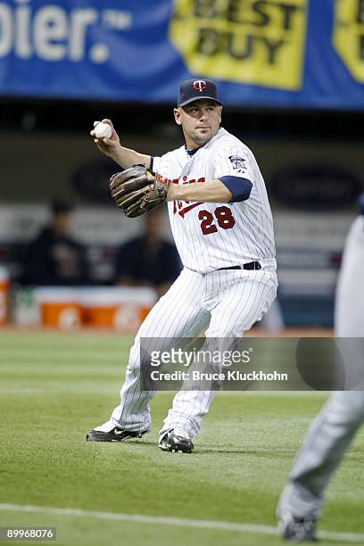 Jesse Crain of the Minnesota Twins throws to first against the Cleveland Indians on August 16, 2009 at the Metrodome in Minneapolis, Minnesota. The...