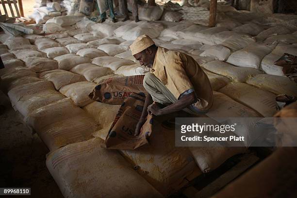 Man helps to distribute flour at a United Nations food distribution center in Dadaab, the world�s biggest refugee complex August 20, 2009 in Dadaab,...