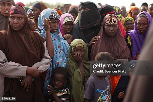 Women and children wait in line at a processing center for new arrivals in Dadaab, the world�s biggest refugee camp August 20, 2009 in Dadaab, Kenya....