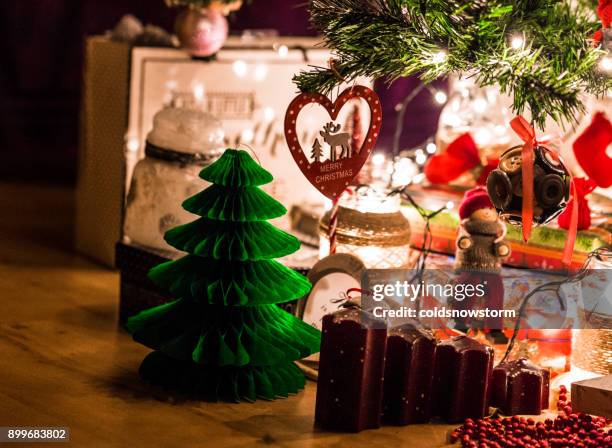 illuminated christmas display beneath the christmas tree - christmas presents under tree stock pictures, royalty-free photos & images