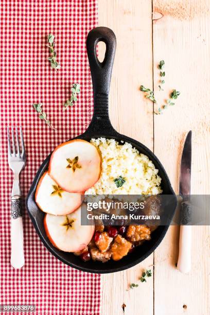pork stew with dried cranberry served with couscous in a pan, selective focus - homemade apple sauce stock pictures, royalty-free photos & images