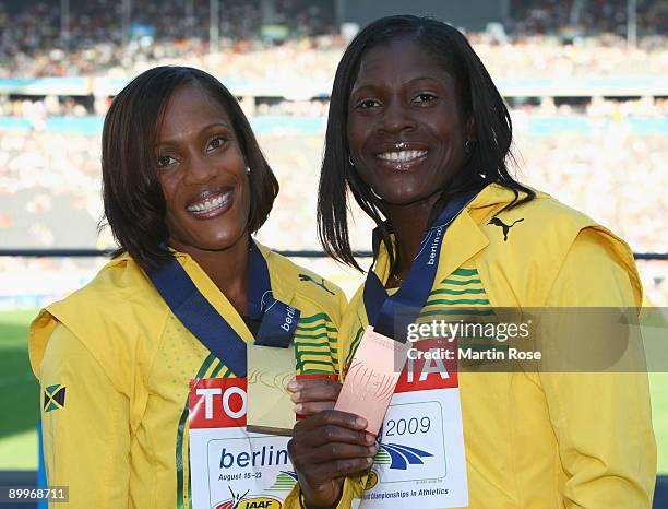 Brigitte Foster-Hylton of Jamaica celebrates winning the gold medal and Delloreen Ennis-London of Jamaica the bronze medal during the medal ceremony...