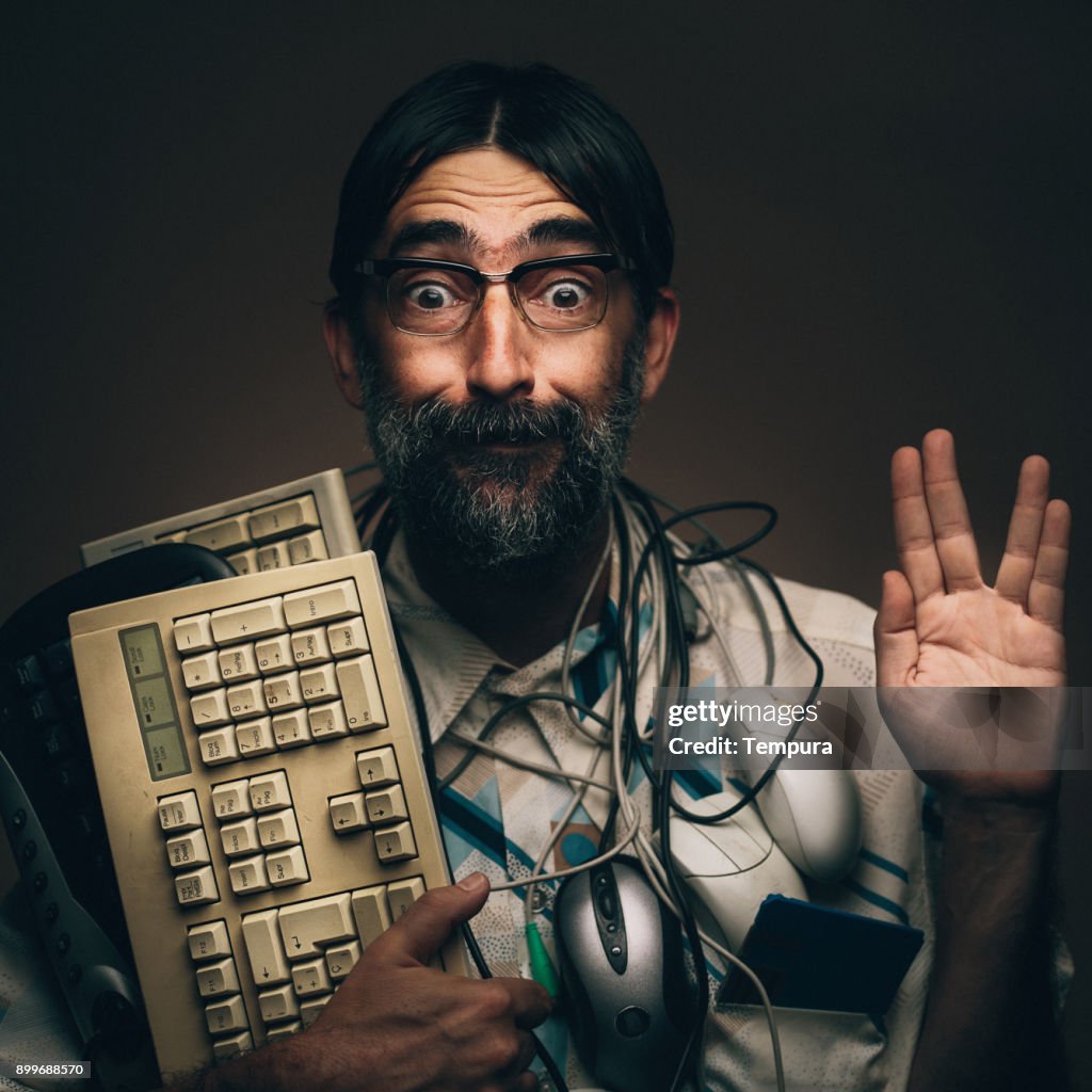 Geek happy with his retro styled technology and computer equipment